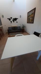 uma mesa branca numa sala de estar com um sofá em LOFT GB em Córdoba