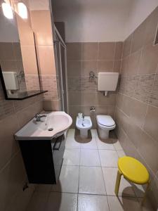 a bathroom with a sink and a toilet at Hotel Brenta in Parma