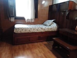 - un petit lit dans une chambre avec fenêtre dans l'établissement El balcón de la Tata, à San Salvador de Jujuy