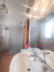 a bathroom with a white sink and a mirror at 1000MigliaHouse in Brescia +61 photos