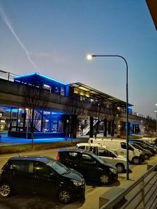 a parking lot with cars parked in front of a gas station at 1000MigliaHouse in Brescia