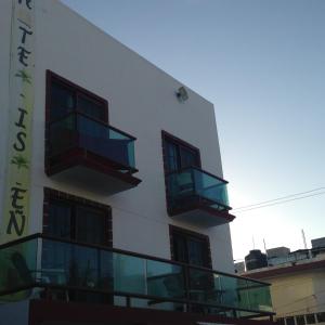 a building with two balconies on the side of it at Hotel Isleño in Isla Mujeres