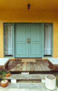 a front door of a house with blue doors at INARA Siargao in General Luna