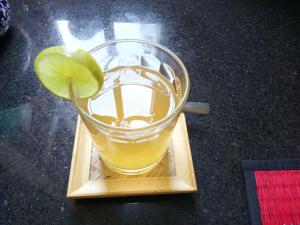 a drink on a wooden plate with a lime on it at Seagull Guesthouse Kampot in Kampot