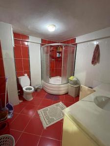 a red and white bathroom with a toilet and a shower at Private Room in Istanbul #76 in Istanbul
