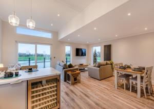 a living room with a kitchen and a dining room at Hambleton Lakeside Lodges in Poulton le Fylde