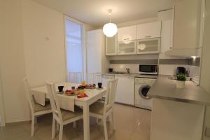 a kitchen with a table and chairs and a kitchen with a sink at Stay Nexus Galaxy Center in Sofia