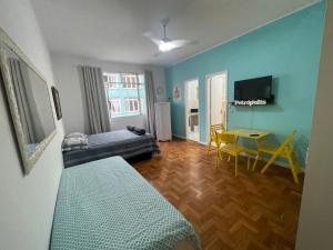 a living room with a bed and a table at New FLAT 504 in Petrópolis