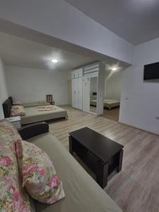 a large room with two beds and a table at AS Apartments in Ulcinj