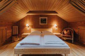 a bedroom with a large bed in a wooden room at Residence Obermoarhof - comfortable apartments for families, swimmingpool, playing-grounds, Almencard in Vandoies