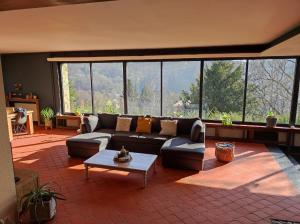 a living room with a couch and a table at Villa Viveye in Ferrières