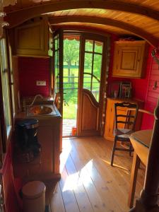 a kitchen with a sink and a stove in a room at ROULOTTE CAPUCINE in Ablon