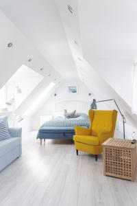 a bedroom with a bed and a yellow chair at Fulinowo - Kuźnica in Kuźnica +261 photos