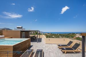 a patio with a pool and chairs on a roof at Casa Belvedere Apartments in Kournás
