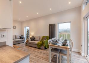 a kitchen and living room with a table and chairs at Hambleton Lakeside Lodges in Poulton le Fylde