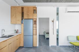 a kitchen with a refrigerator and a dining room at Sea view in Kabri