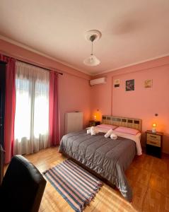 a bedroom with two beds and a large window at Guesthouse Alexandros in Pýli