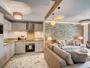 a living room with a couch and a kitchen at Appartement Courchevel 1550, 4 pièces, 6 personnes - FR-1-562-37 in Courchevel