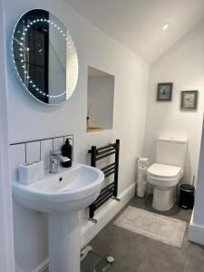 a white bathroom with a sink and a toilet at Family & pet friendly house + private garden in Oakhill