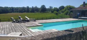 un patio con 2 sillas y una piscina en Château de Montautre en Fromental