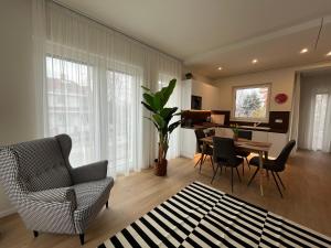 a living room with a table and chairs and a dining room at Nature in the City upper storey Bestern in Szeged