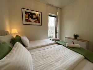 a bedroom with two beds and a window at Nature in the City upper storey Bestern in Szeged