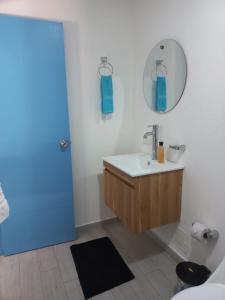 a bathroom with a sink and a mirror at CABAÑA EN ISLA FRENTE A CARTAGENA in Cartagena de Indias