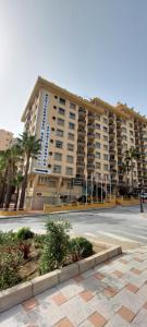 a large apartment building with a street in front of it at Los Boliches Apartamentos Mediterraneo Real in Fuengirola