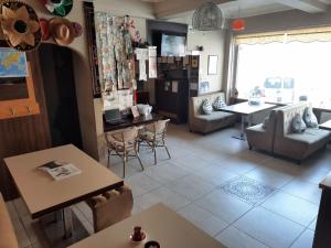a living room with tables and chairs and a large window at Second Home Hostel in Istanbul +48 photos