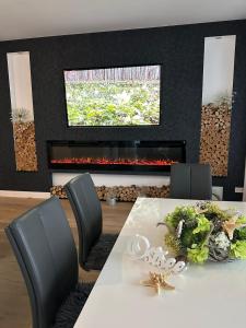 a dining room with a table and a fireplace at Viktoria Deluxe direkter Meerblick in Ostseebad Sellin