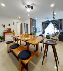 a dining table and chairs in a living room at Ipoh Homestay - Manhattan Condominium with Water Park & Leisure Facilities in Ipoh
