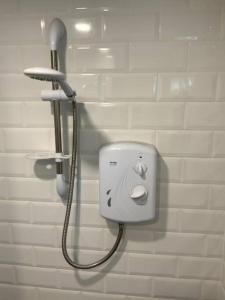 a shower head on a wall in a bathroom at Cabin Retreat in the heart of Warwick. in Warwick