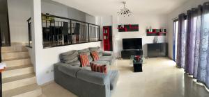 a living room with a couch and a television at Palm mar Relax House in Palm-Mar