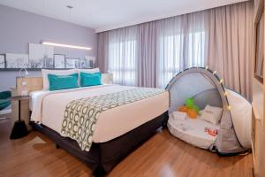 a bedroom with a bed with a tent in it at Mercure Sao Paulo Pinheiros in Sao Paulo