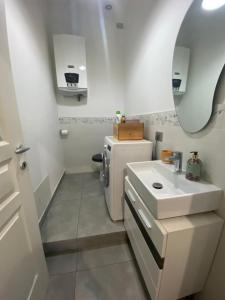 a small bathroom with a sink and a refrigerator at La casa di Betty in Salsomaggiore Terme