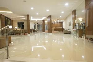 a large lobby with white tile flooring and a lobby at Casablanca Center Hotel in Petrópolis
