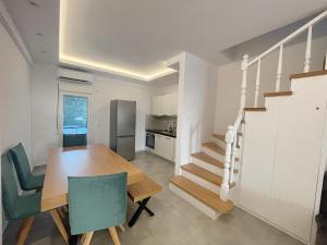 a kitchen and dining room with a table and chairs at Sunrise Luxury House in Pefkochori