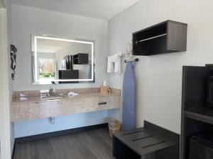 a bathroom with a sink and a mirror at Baymont by Wyndham Rock Hill in Rock Hill