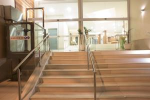 a set of stairs in a building with a glass railing at Casablanca Center Hotel in Petrópolis
