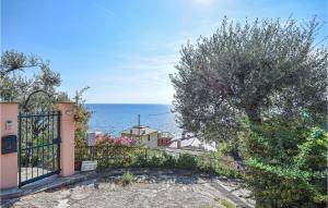 a gate to a house with the ocean in the background at 2 Bedroom Amazing Apartment In Recco in Recco
