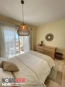 ein Schlafzimmer mit einem großen Bett und einem Fenster in der Unterkunft Beautiful appartment Mijas Costa in Mijas