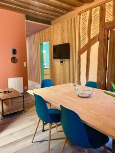 une salle de conférence avec une table en bois et des chaises bleues dans l'établissement Cathédrale, à Moulins