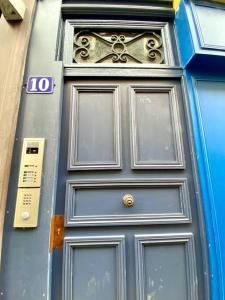 a blue door with a clock on top of it at Cathédrale in Moulins