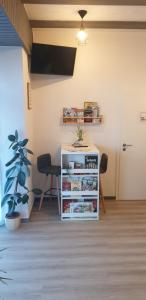 a room with a book shelf and a table at Pension Sonnenblick in Brüel
