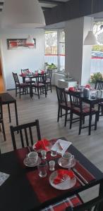 a dining room with tables and chairs in a room at Pension Sonnenblick in Brüel