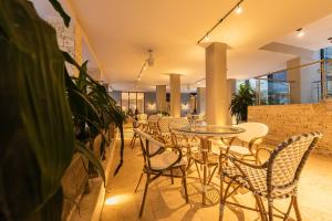 a restaurant with tables and chairs and plants at Madisson Boutique Hotel Cartagena in Cartagena de Indias