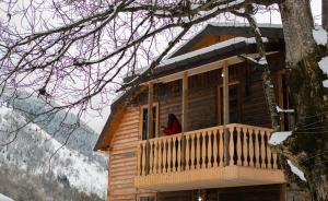 a log cabin with a red item in the window at Feel Funny House Svaneti in Kʼveda Marghi