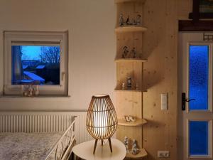 a bedroom with a bed and a lamp next to a window at Apartamento Maria in Kleinheubach