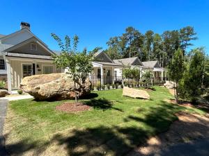 a house with a large rock in the yard at The Cottages at Laurel Brooke in Peachtree City