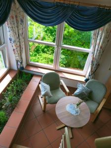 Pokój z 2 krzesłami, stołem i oknem w obiekcie Landgasthaus Zum Erlengrund w mieście Emskirchen